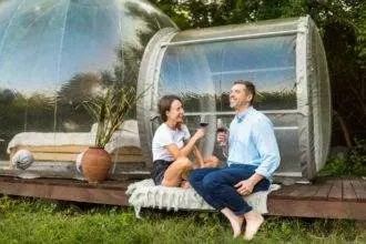 Couple drinking wine at glamping