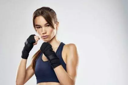 slender woman kickboxing workout fitness martial arts light background